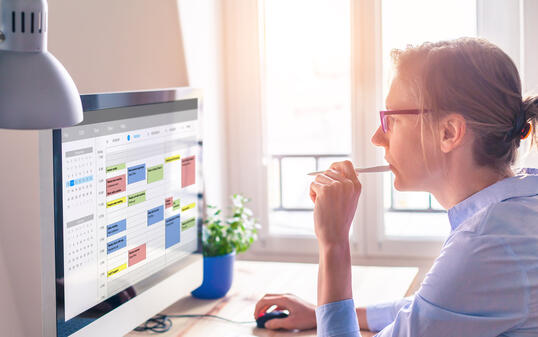 Person using calendar on computer to improve time management, plan appointments, events, tasks and meetings efficiently, improve productivity, organize week day and work hours, business woman, office