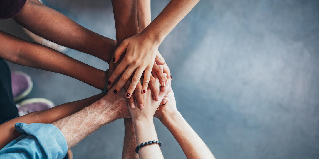 Stack of hands showing unity