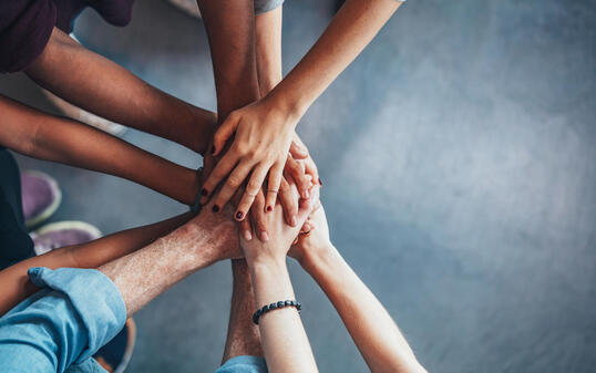 Stack of hands showing unity