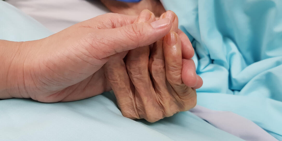 Holding grandmother's hand in the nursing care. Showing all love, empathy, helping and encouragement : healthcare in end of life and palliative concept