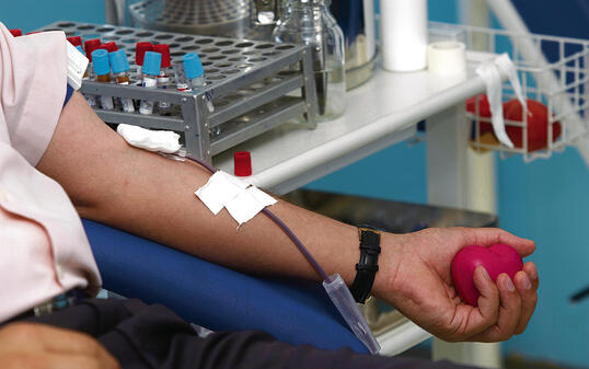 A close up of some blood being extracted from an arm