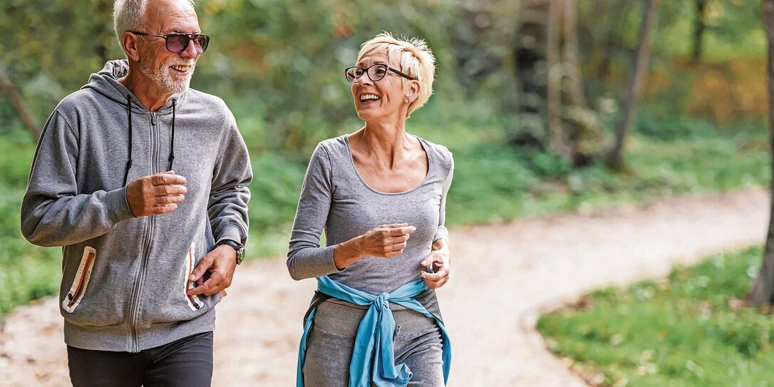 Smiling senior couple jogging in the park