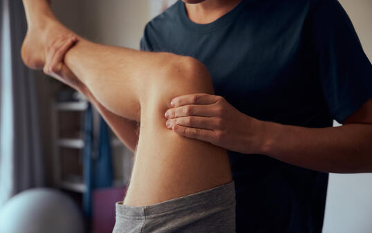 Closeup of physiotherapist hands giving therapy treatment to patient