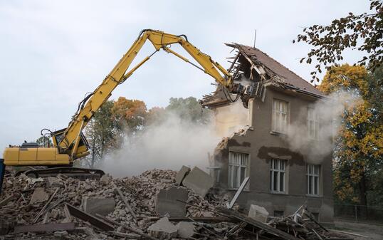 digger demolishing houses