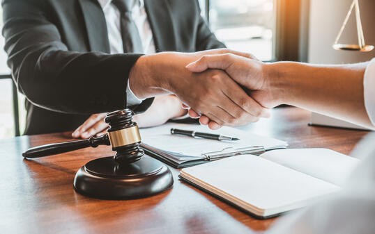 Businessman shaking hands to seal a deal Judges male lawyers Consultation legal services Consulting in regard to the various contracts to plan the case in court.